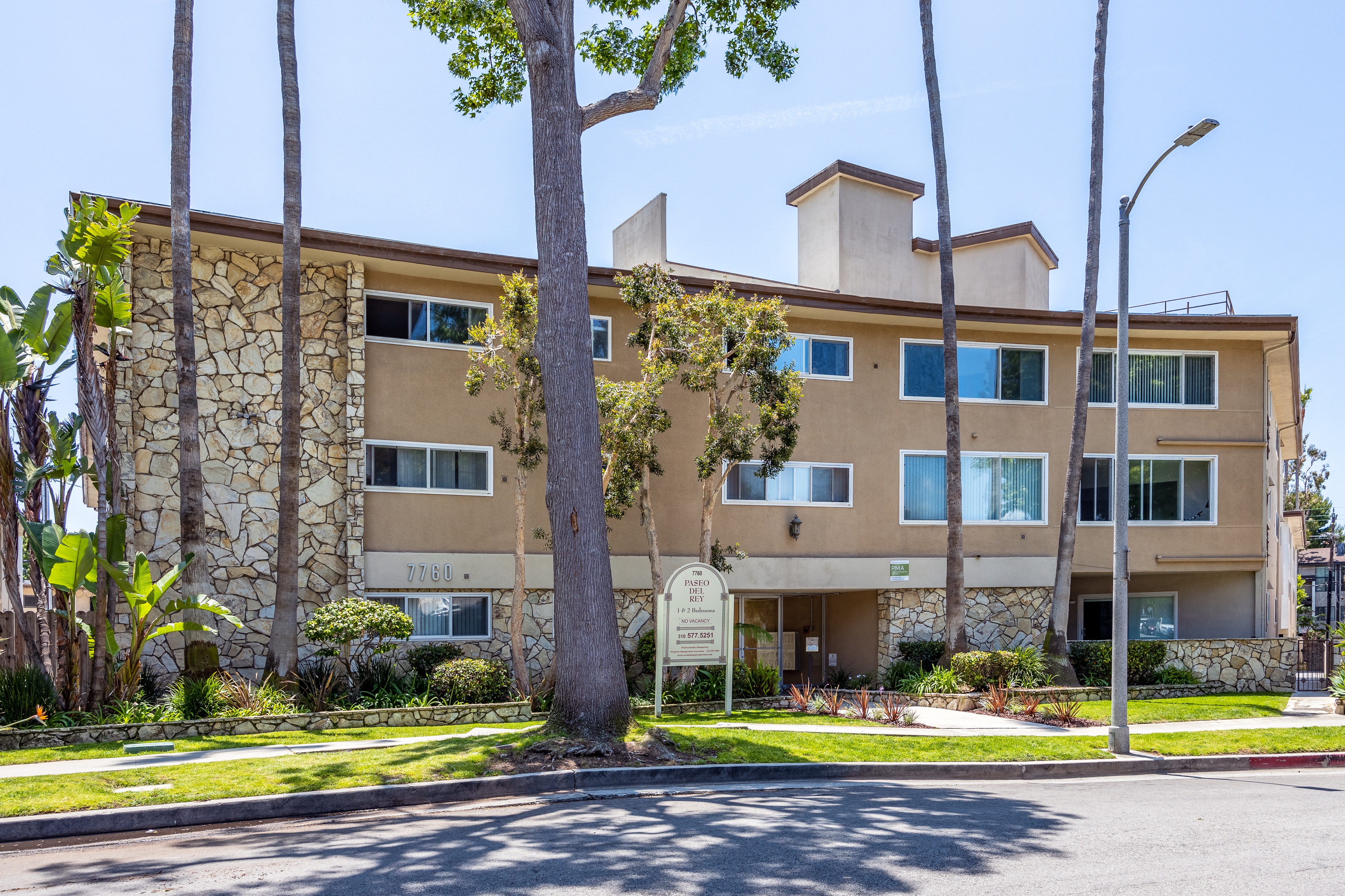 a large apartment building with a sign in front of it